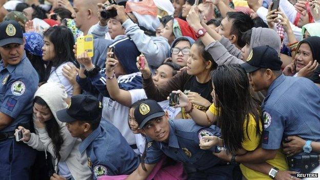 Members of the Philippine National Police prevent well-wishers from moving forward as Pope Francis' motorcade passes by in Manila, 18 January 2015