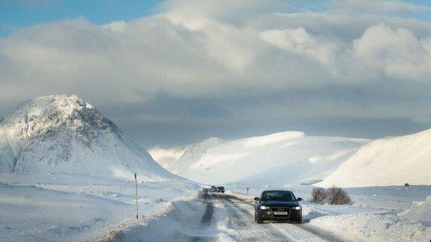 Cars going through snow near Rannoch Moor in Glencoe