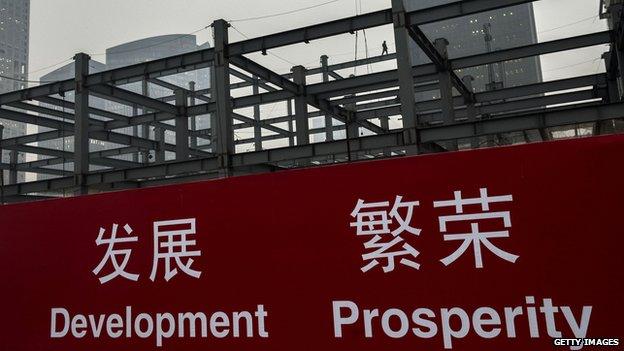 Chinese workers on steel beams at a construction site in Beijing