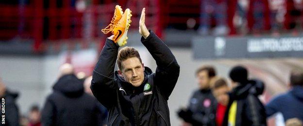 Celtic playmaker Kris Commons applauds the visiting Celtic supporters at New Douglas Park