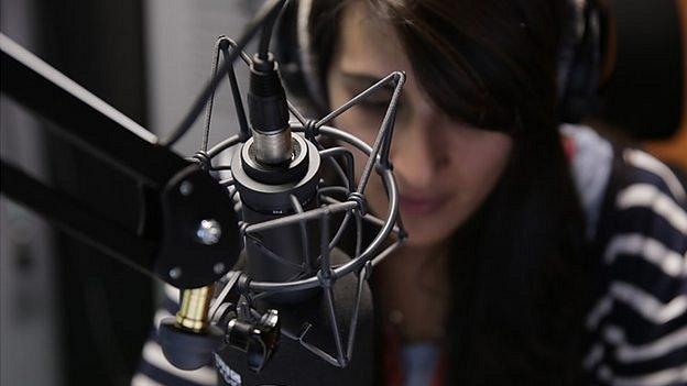 Woman at radio microphone