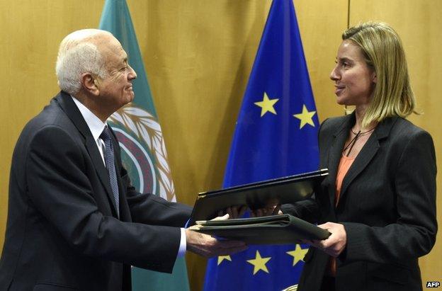 Arab League Secretary General Nabil al-Arabi (left) exchanges documents with the EU's Federica Mogherini in Brussels, 19 January