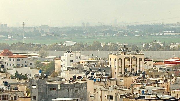 View from Qalqilya, with concrete section of West Bank barrier in background