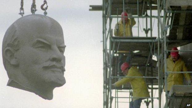 The huge granite head of Berlins Lenin statue is hanging at a crane during its dismantling in Berlin November 13, 1991.