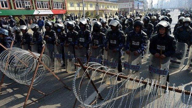 Nepalese riot police stand guard near the Constitutional Assembly building in Kathmandu during a nationwide general strike led by the Unified Communist Party of Nepal (Maoist) in Kathmandu on January 20, 2015