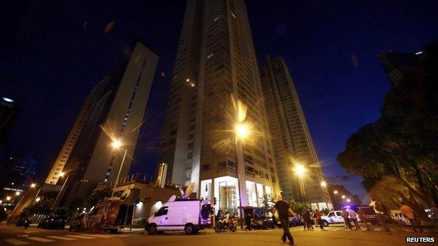 Media trucks are seen outside an apartment building where Alberto Nisman lived in Buenos Aires on 19 January , 2015.