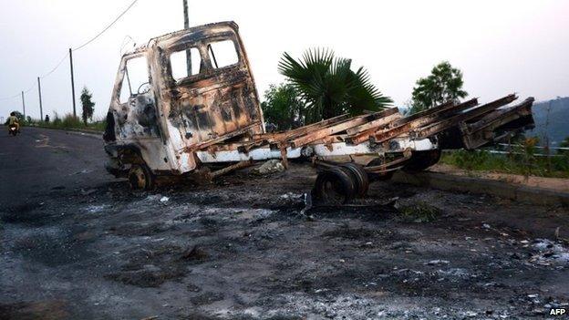 A picture shows a burnt truck on the road leading the University of Kinshasa, where demonstrations on 19 January 2015 in Kinshasa, to protest against moves to allow Democratic Republic of Congo's president to extend his hold on power.