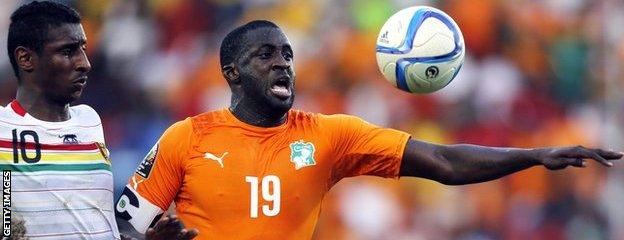 Guinea's Kevin Constant and Yaya Toure of Ivory Coast