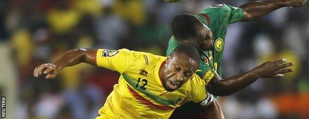 Mali"s Seydou Keita (left) and Franck Kom of Cameroon challenge for the ball