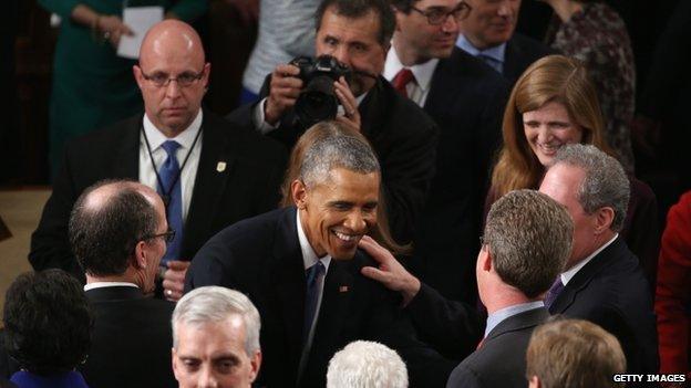 President Barack Obama greets members of Congress after delivering the State of the Union address in the House chamber