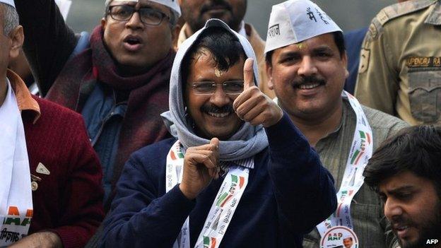 Aam Aadmi Party (AAP) party chief Arvind Kejriwal greets supporters during a road show in New Delhi on January 20, 2015