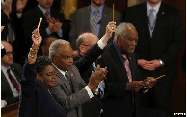 Members of Congress wave pencils in honour of Charlie Hebdo cartoonists