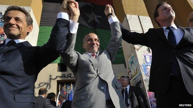 President Sarkozy, Libyan NTC head Mustafa Abdul Jalil and David Cameron raise hands in Benghazi , September 2011