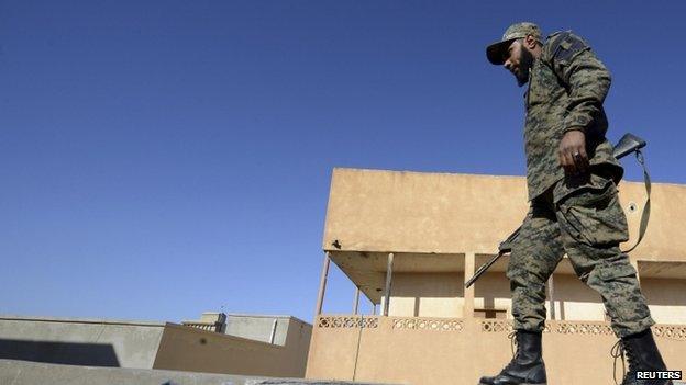 A member of Libyan pro-government forces, who are backed by the locals, holds a weapon during clashes with the Shura Council of Libyan Revolutionaries in Benghazi