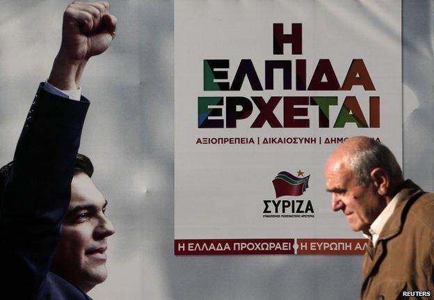 A man walks past a banner with an image of Syriza party leader Alexis Tsipras at the party's pre-election kiosk in Athens 15 January 2015