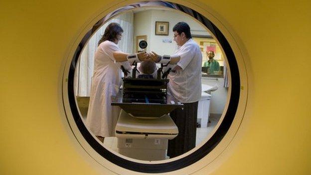 A woman undergoes a CT scan