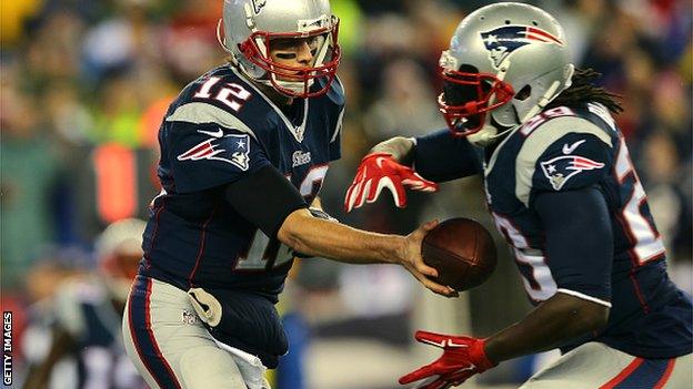 Tom Brady (12) of the New England Patriots hands the ball off to LeGarrette Blount