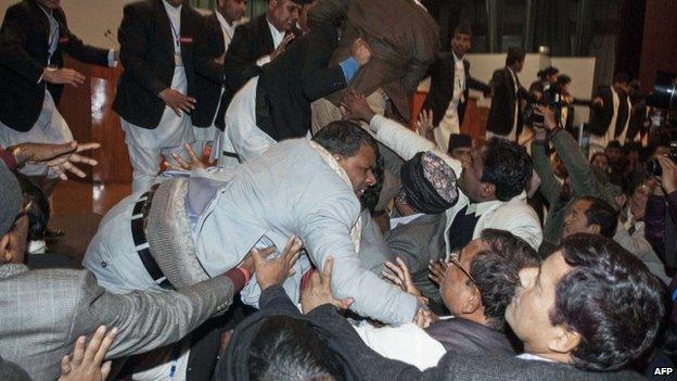 Nepalese constituent assembly members scuffle with security officers at parliament in Kathmandu early on January 20, 2015.