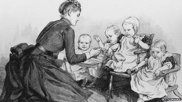 A nurse feeds children in the baby room at a home run by the NSPCC
