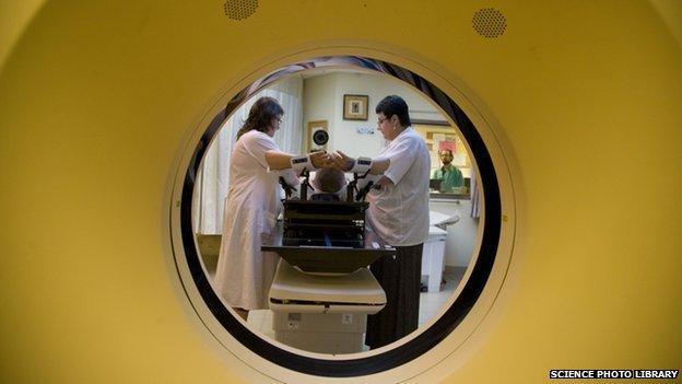 A woman undergoes a CT scan