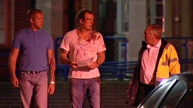 Alan Lethbridge (centre) in a blood-soaked T-shirt