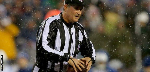 Umpire Carl Paganelli holds one of the match balls during a stoppage in play