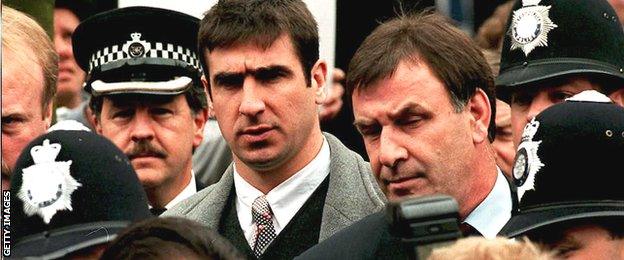 Eric Cantona arrives at Croydon Crown Court amid a throng of policemen for his appeal hearing