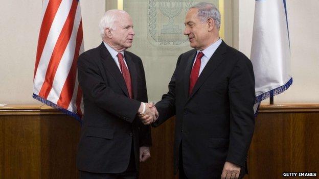 Israeli Prime Minister Benjamin Netanyahu (R) shakes hands with US Senator John McCain during a meeting between Israeli officials and an US Senators and members of their delegation on January 19, 2015 at the Prime Minister's office in Jerusalem