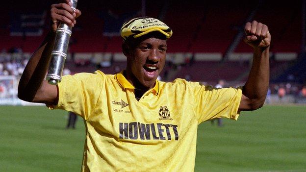 Dion Dublin celebrating promotion with Cambridge United