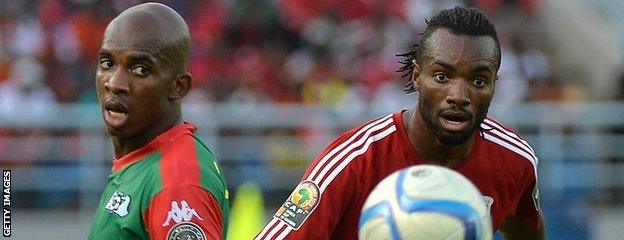 Equatorial Guinea's midfielder Javier Balboa (right) challenges Burkina Faso's midfielder Charles Kabore