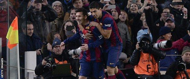 Lionel Messi and Luis Suarez celebrate