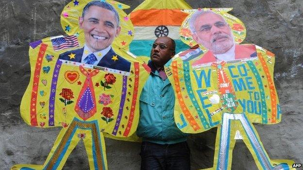 An Indian kitemaker poses with kites with images of US President Barack Obama and Indian PM Narendra Modi (in Amritsar on January 21, 2015.