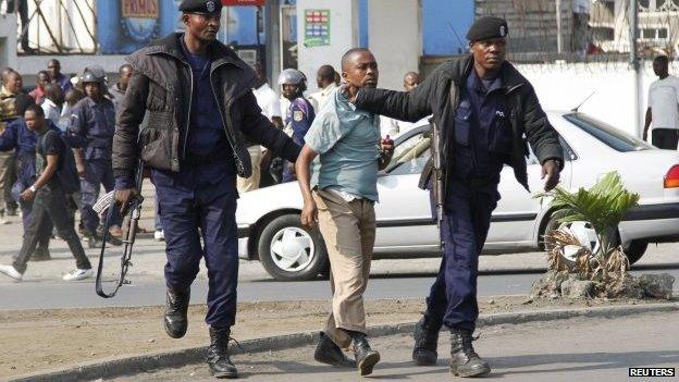 Riot policemen detain a demonstrator during a nationwide protest as opposition parties tried to block a change in the law that may delay elections - Goma, DR Congo, 19 January 2015