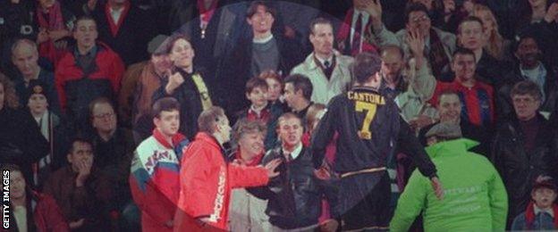 Matthew Simmons (leather jacket) taunts Eric Cantona as Palace fan Cathy Churchman (red scarf, left of Simmons), looks on