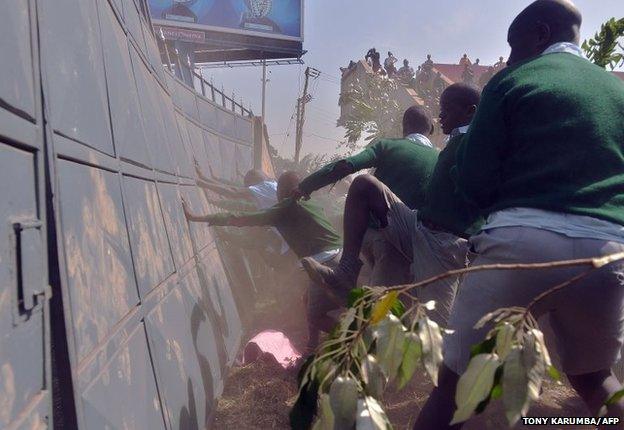 School children from the Lang'ata road primary attempt to force their way through a gate