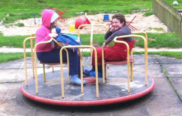 Ellie and Toby on a roundabout