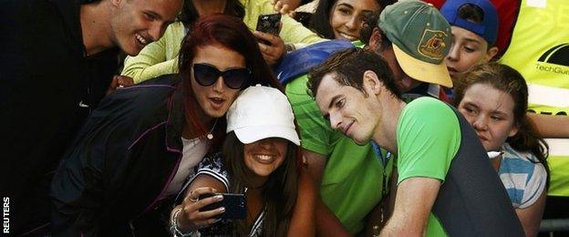 Andy Murray of Britain poses for a photograph with supporters after defeating Joao Sousa of Portugal