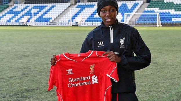 Asisat Oshoala holds up LFC shirt