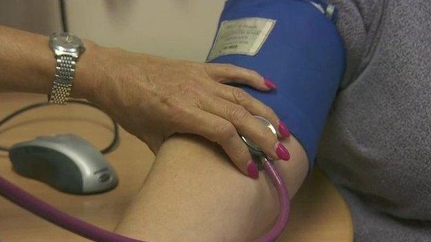 Doctor checking patient's blood pressure