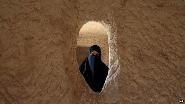 Saudi woman poses for photo inside the Qasr al-Bint tombs complex in the desert archaeological site of Madain Saleh, in Al Ula city, 10 May 2012