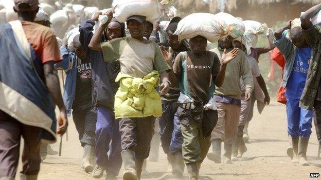 Men carrying ore from a mine not far from Goma in DR Congo, which borders Rwanda