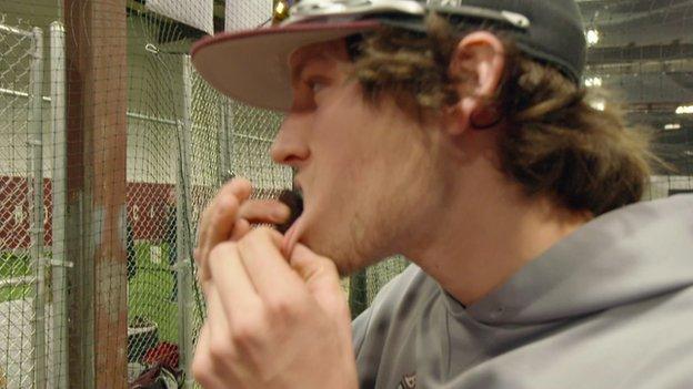 Man stuffing tobacco in his lip