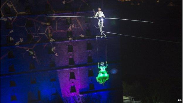 Cyclist rides on high wire between Bristol warehouses