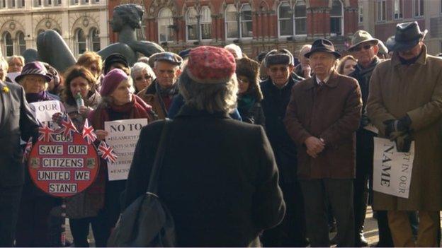 A speaker addresses the rally