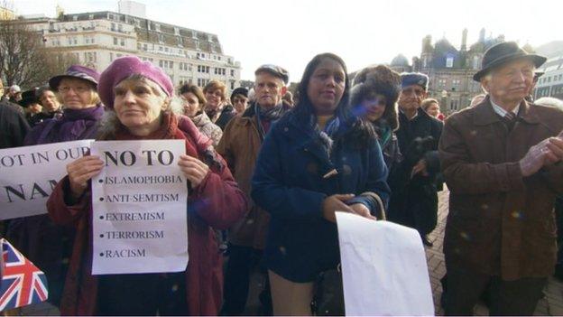 Attendees of the rally hold signs