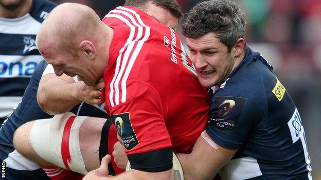 Munster's Paul O'Connell is tackled by Mark Easter and Tom Brady of Sale