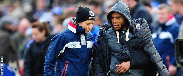 Bath's England centre Kyle Eastmond is led away with his arm in a sling