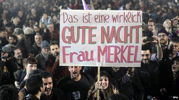 Syriza supporters in Athens hold a poster: "This is a really good night, Mrs Merkel"