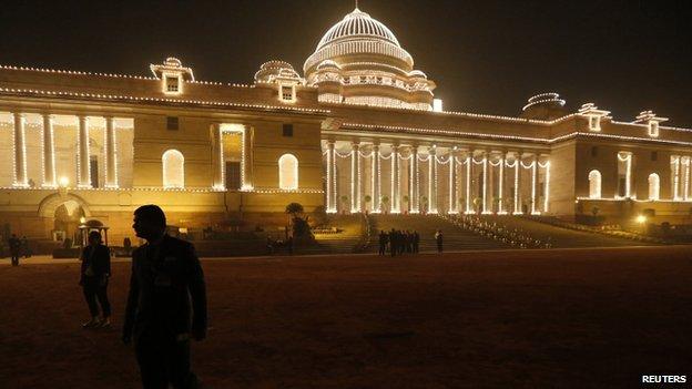 Visitors walk around the grounds of the Rashtrapati Bhavan presidential palace, which has been illuminated for Republic Day, before an official state dinner for U.S. President Barack Obama at the palace in New Delhi January 25, 2015.