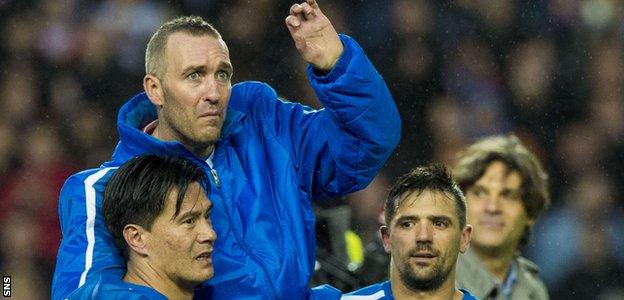 Michael Mols and Nacho Novo carry Fernando Ricksen round Ibrox